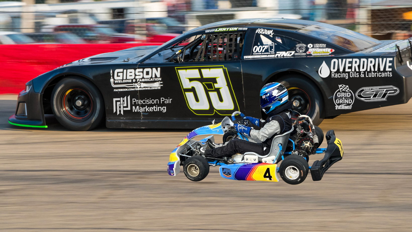 Small go-kart on a racetrack with a large race car in the background